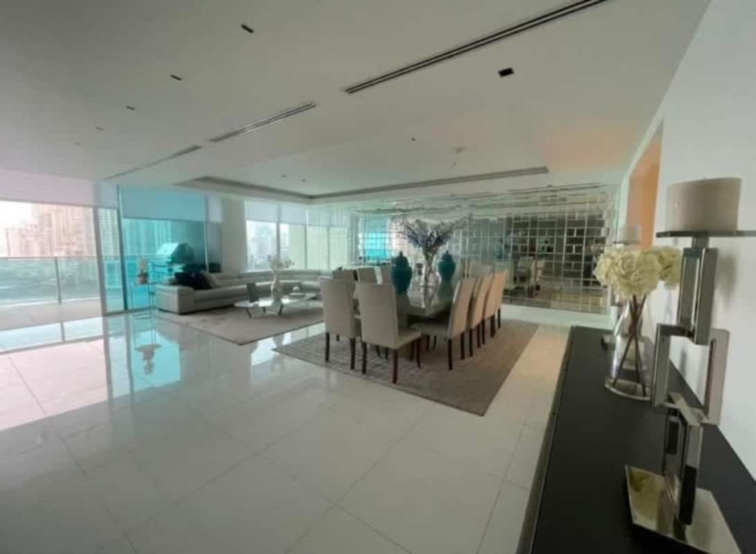 Luxury living dining area with floor-to-ceiling windows, city and ocean views, modern decor at Ocean Club Panama