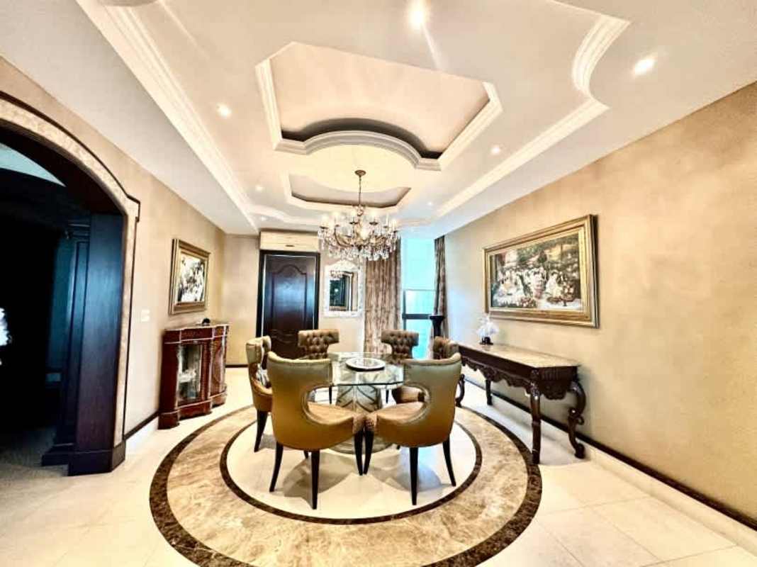 Elegant dining space with chandelier, coffered ceiling and marble flooring Costa del Este Panama