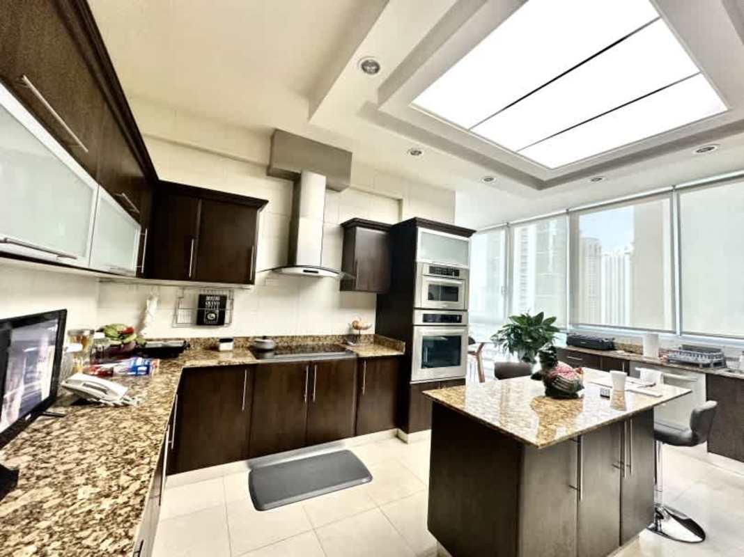 Elegant bedroom with tray ceiling, tufted bed, hardwood floors Costa del Este Panama