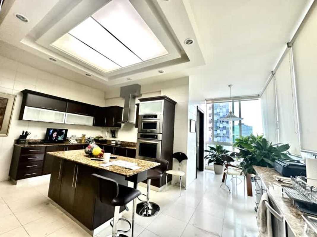 Classic style bedroom with chandelier, tufted bed and city views PH Titanium Costa del Este