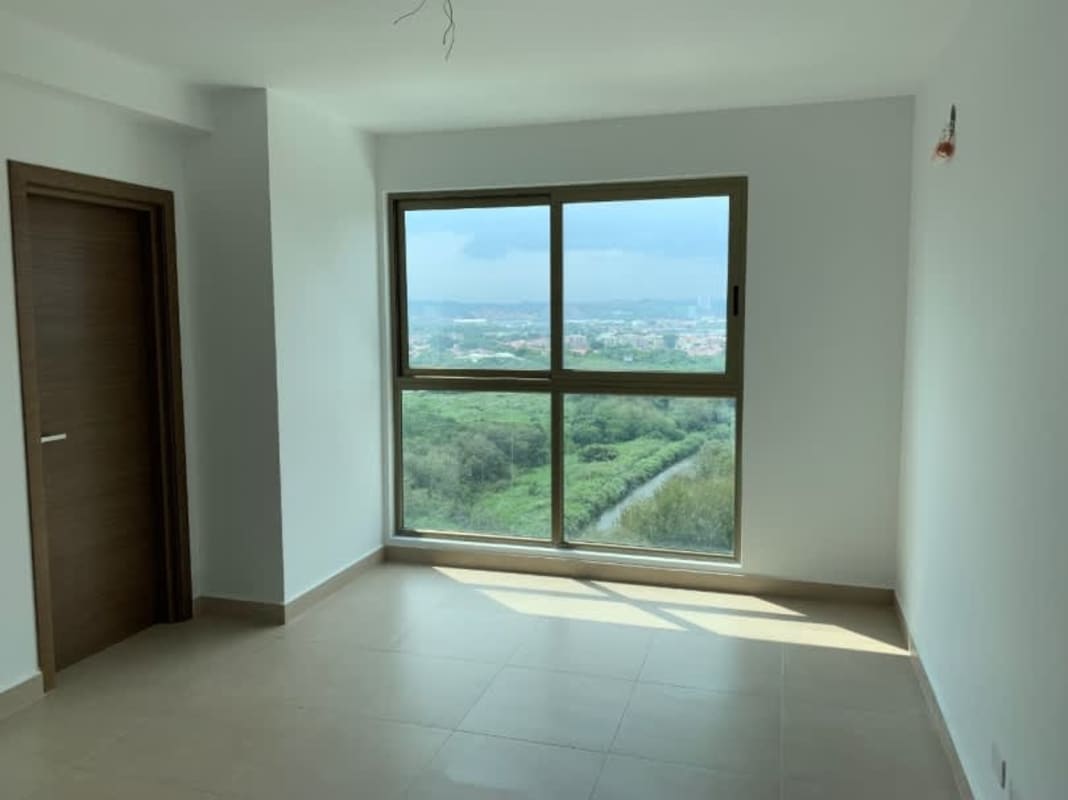 Kitchen with gray cabinets, double sink, and large window overlooking downtown Costa del Este at PH Park Lane Panama
