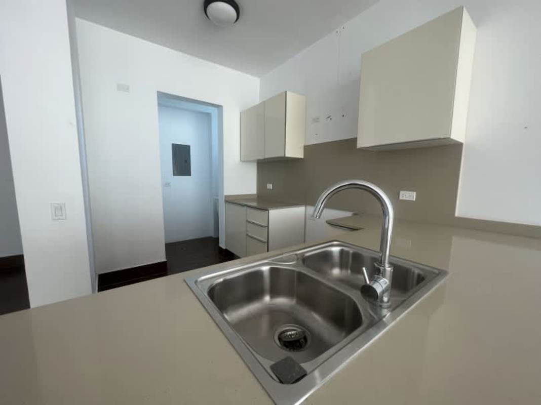 Contemporary kitchen with beige cabinets, double sink in PH Costamare Costa Sur
