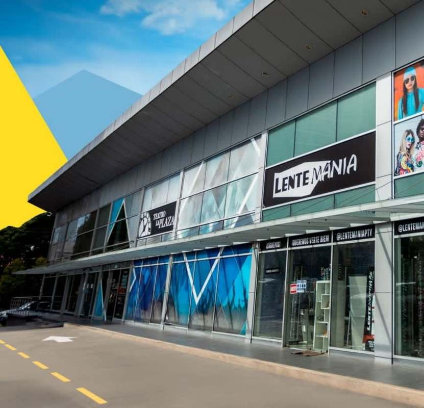Retail shopping center with modern glass storefronts and signage at PH Obarrio Plaza Panama City