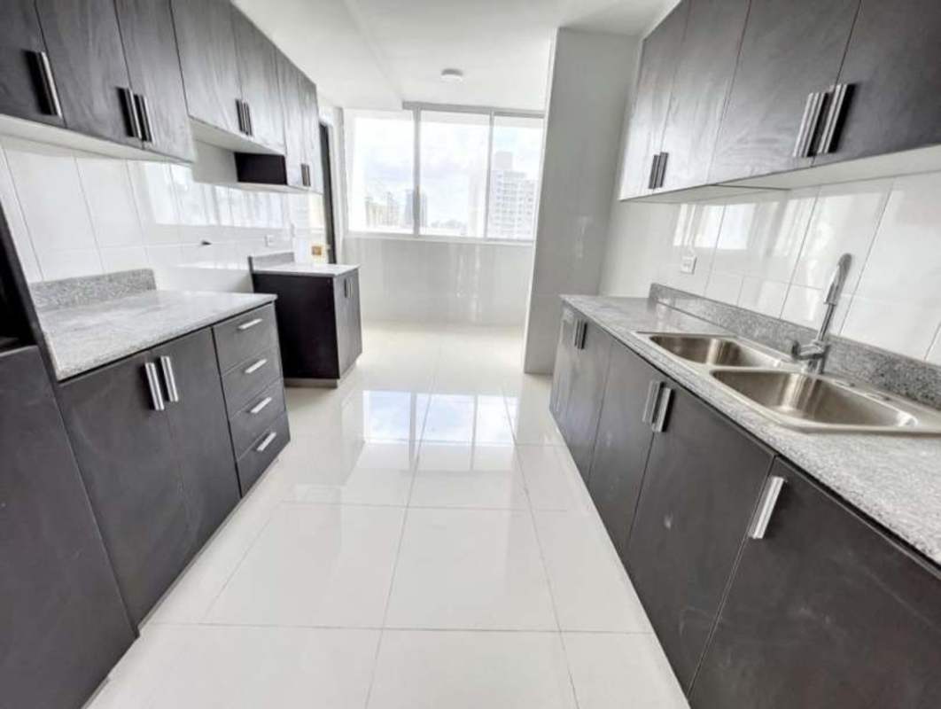 Modern granite kitchen with cabinets and window city view in El Cangrejo Panama