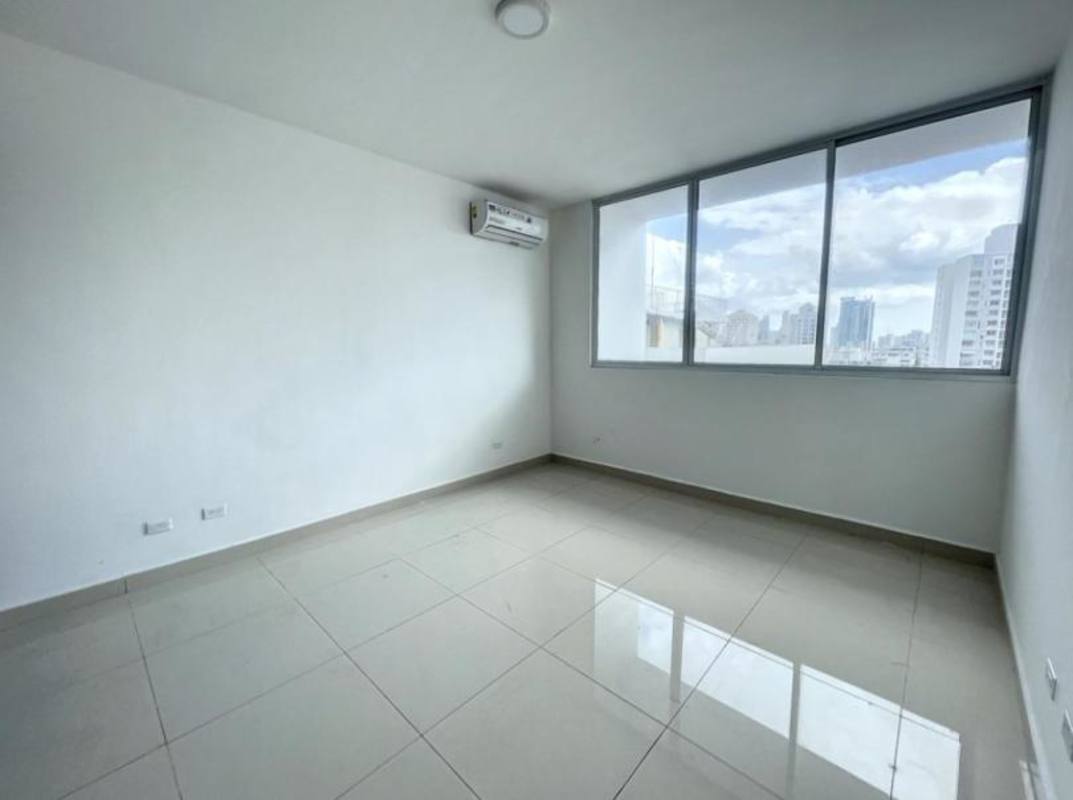 Bright bedroom with large window overlooking city skyline in El Cangrejo Panama