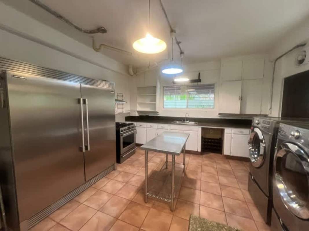 Spacious covered terrace surrounded by garden at Clayton Panama home for rent