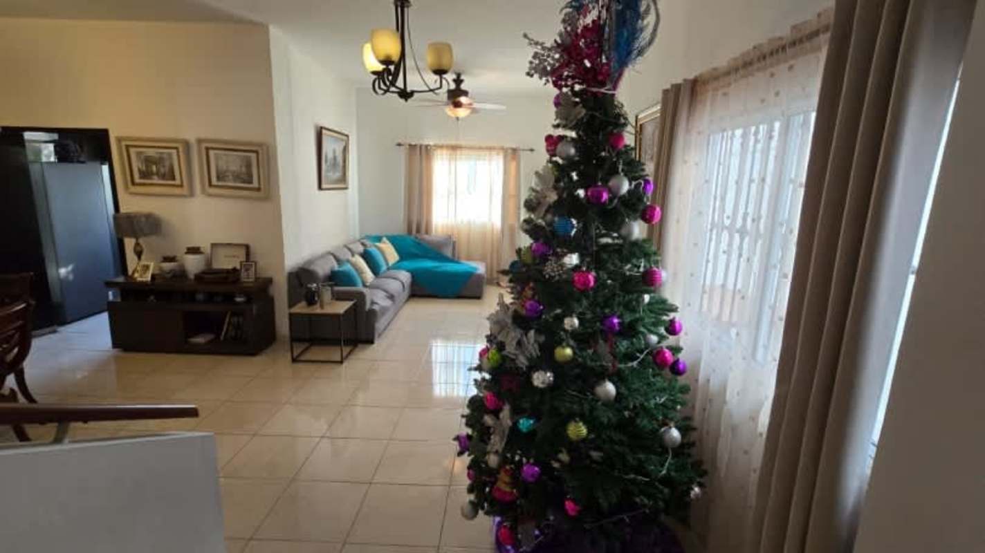 Open plan living dining room with staircase, chandeliers, festive decorations in Hato Pintado