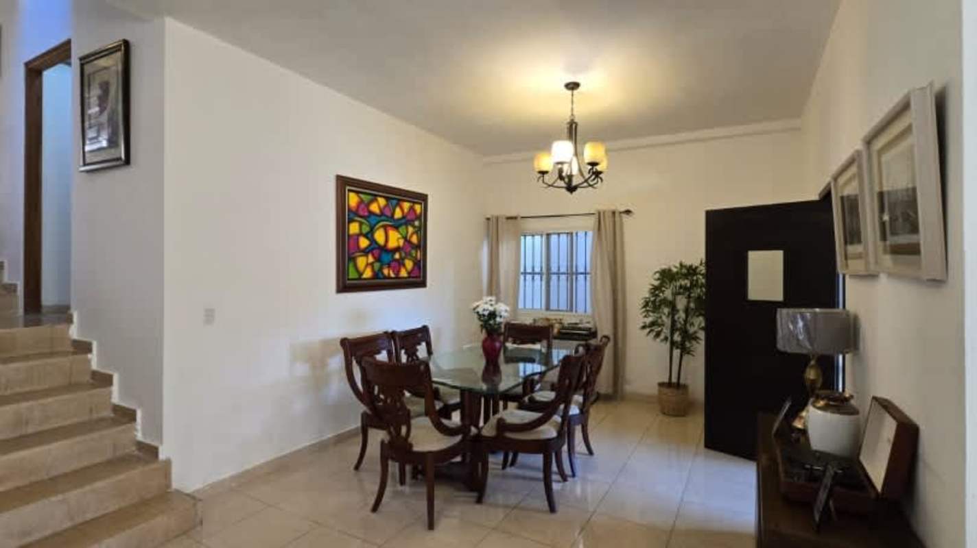 Interior stairwell with decorative planter, partial view living room in Hato Pintado