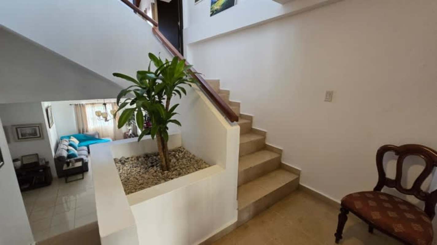 Bedroom with vaulted wood ceiling, AC, window drapes in Hato Pintado house Panama
