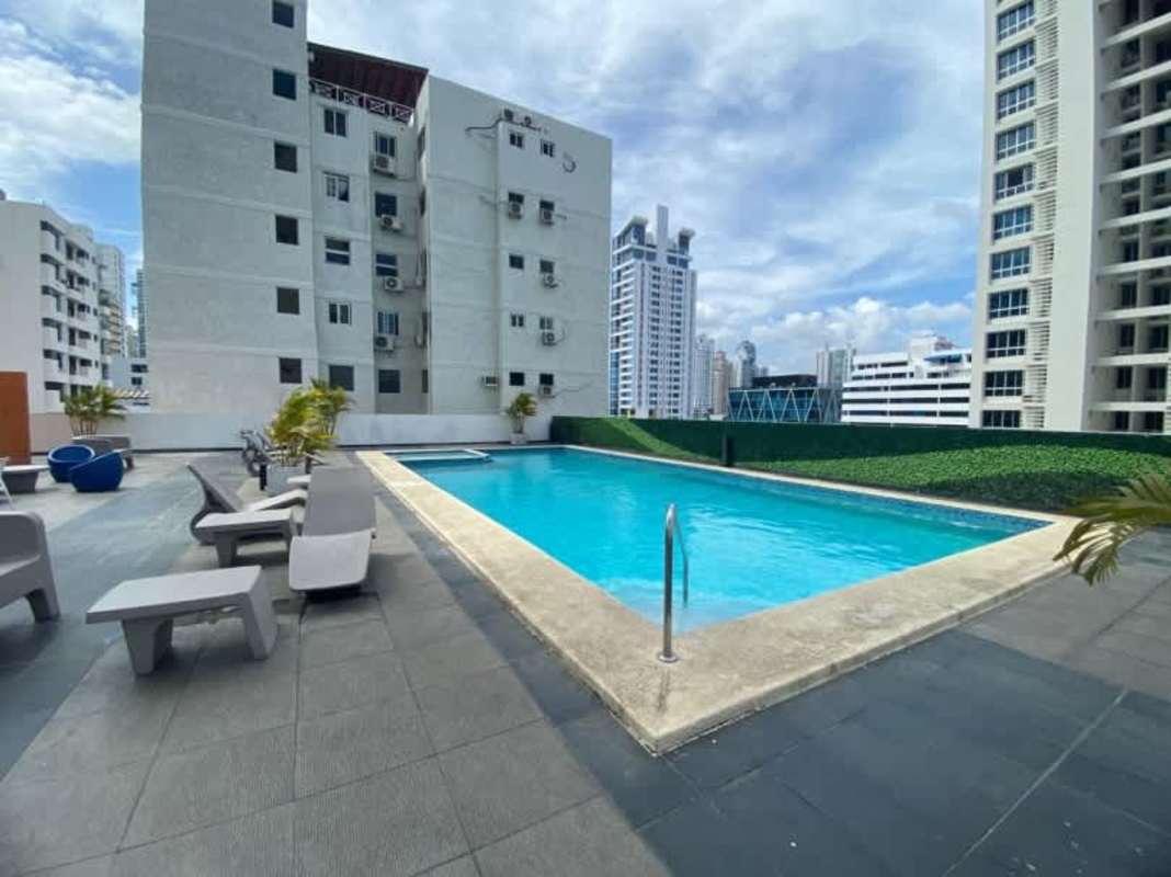 Rooftop pool area with lounge chairs overlooking Panama City skyline PH Titanium San Francisco