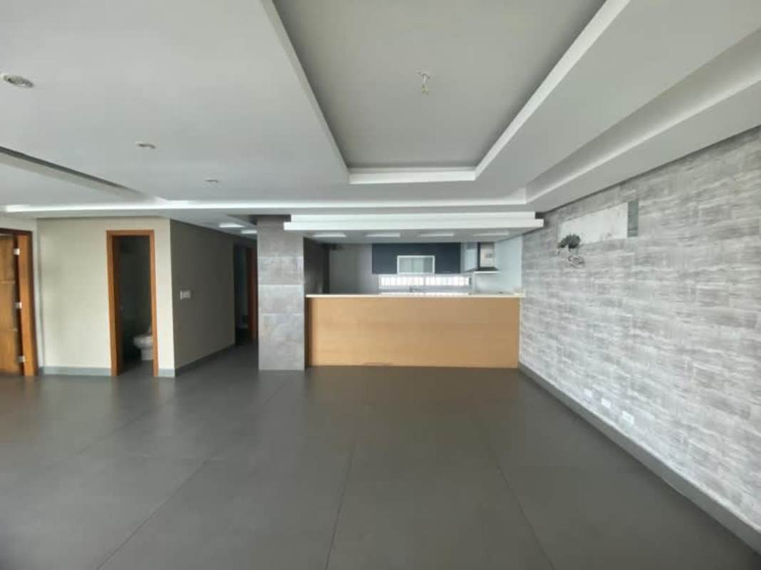Bright living room with large sliding glass doors open to balcony ocean views PH Coco del Mar Panama