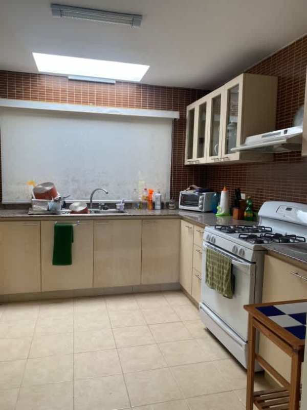 Bright enclosed sunroom with large windows overlooking rainforest in Cerro Azul Panama