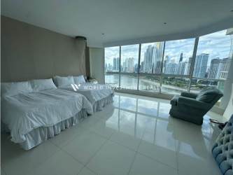 Master bedroom with large windows and ocean view at PH Peninsula Punta Paitilla Panama City