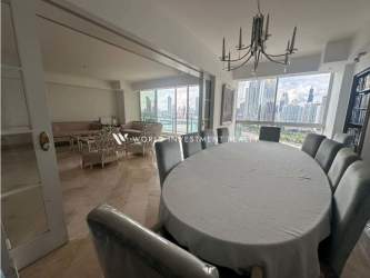 Dining room with floor-to-ceiling windows and oceanview at PH Peninsula Punta Paitilla Panama