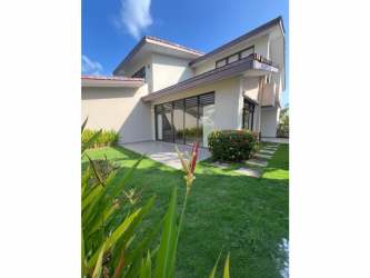 Bright living room with tall ceilings, large windows, and ceramic floors in Panama Pacifico