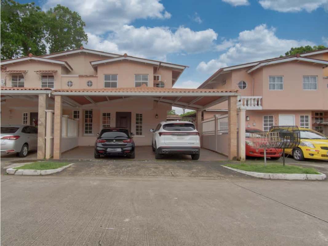 Two-story foreclosure house with covered carport and gate in Condado del Rey Panama City