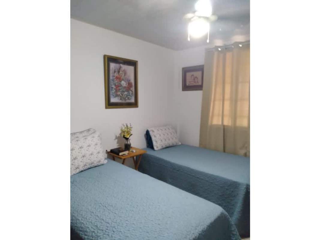 Traditional bedroom with twin beds, AC fans, large window at PH Cantabria V Las Acacias Panama