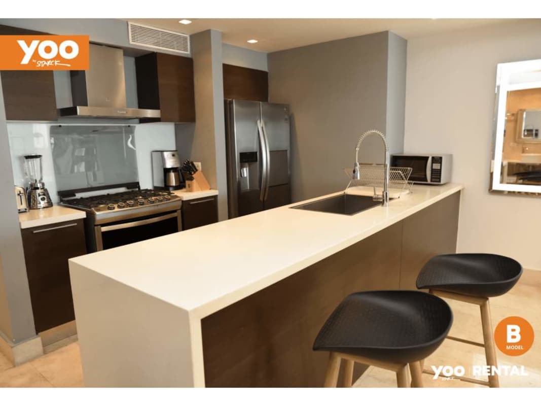 Modern dining space with glass table, ocean views PH Yoo Panama