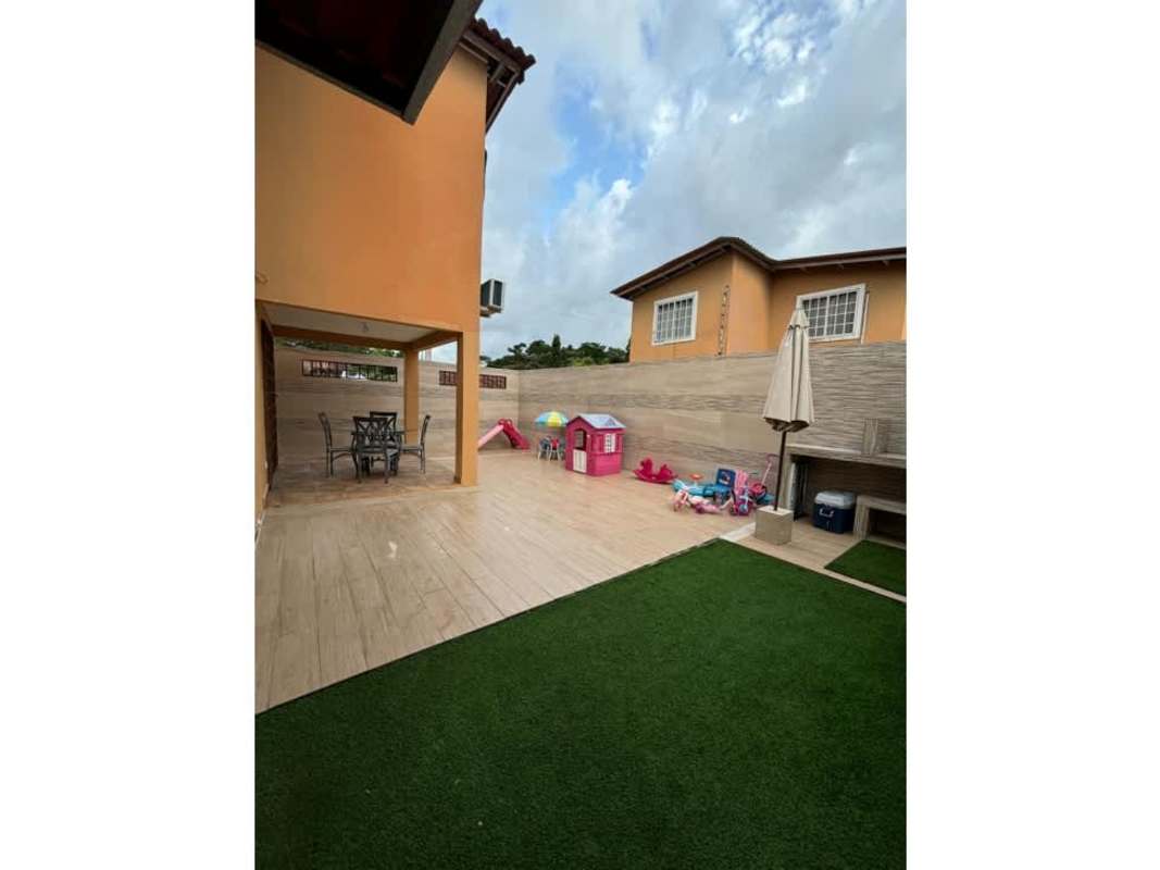 Open-plan living and dining area with tile floors, large windows, and ceiling fan in Mañanitas Panama