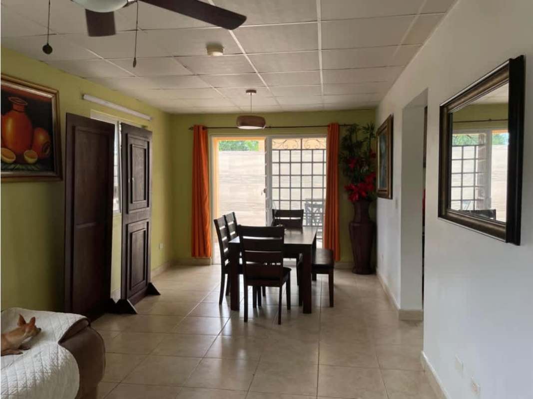 Tiled backyard patio with green play space in Villas del Bosque Mañanitas Panama City