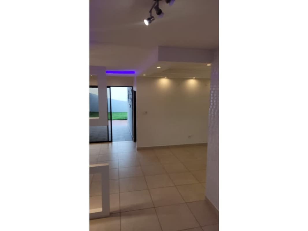 Living area with recessed LED ceiling lights and large windows in PH Sierra Nevada Paseo del Norte Panama City