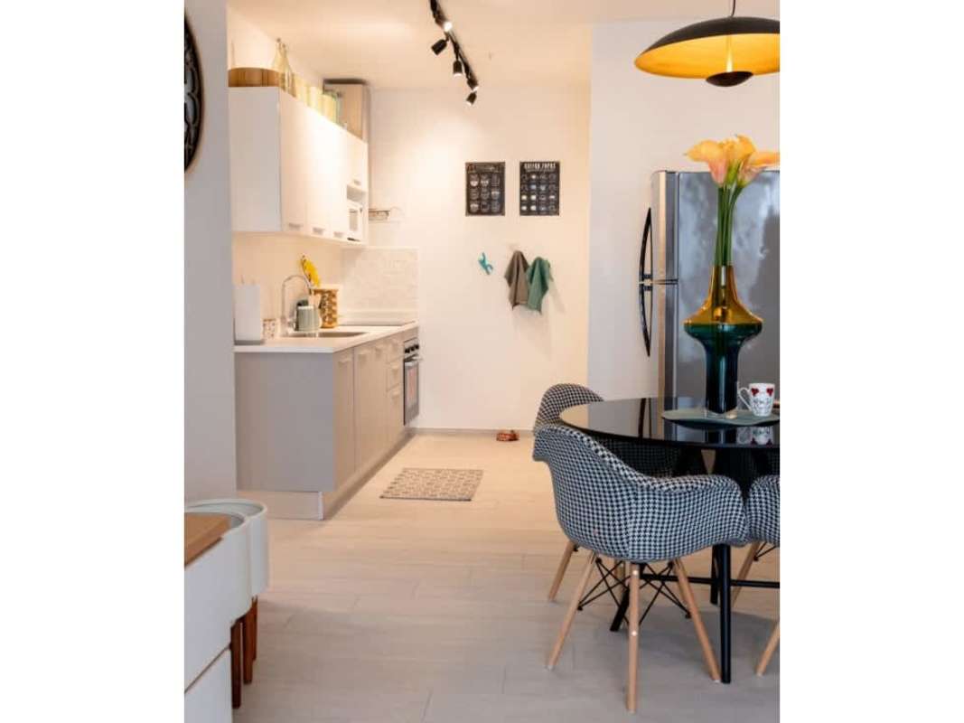 Dining area with modern cabinetry and bright natural lighting in PH Demetra