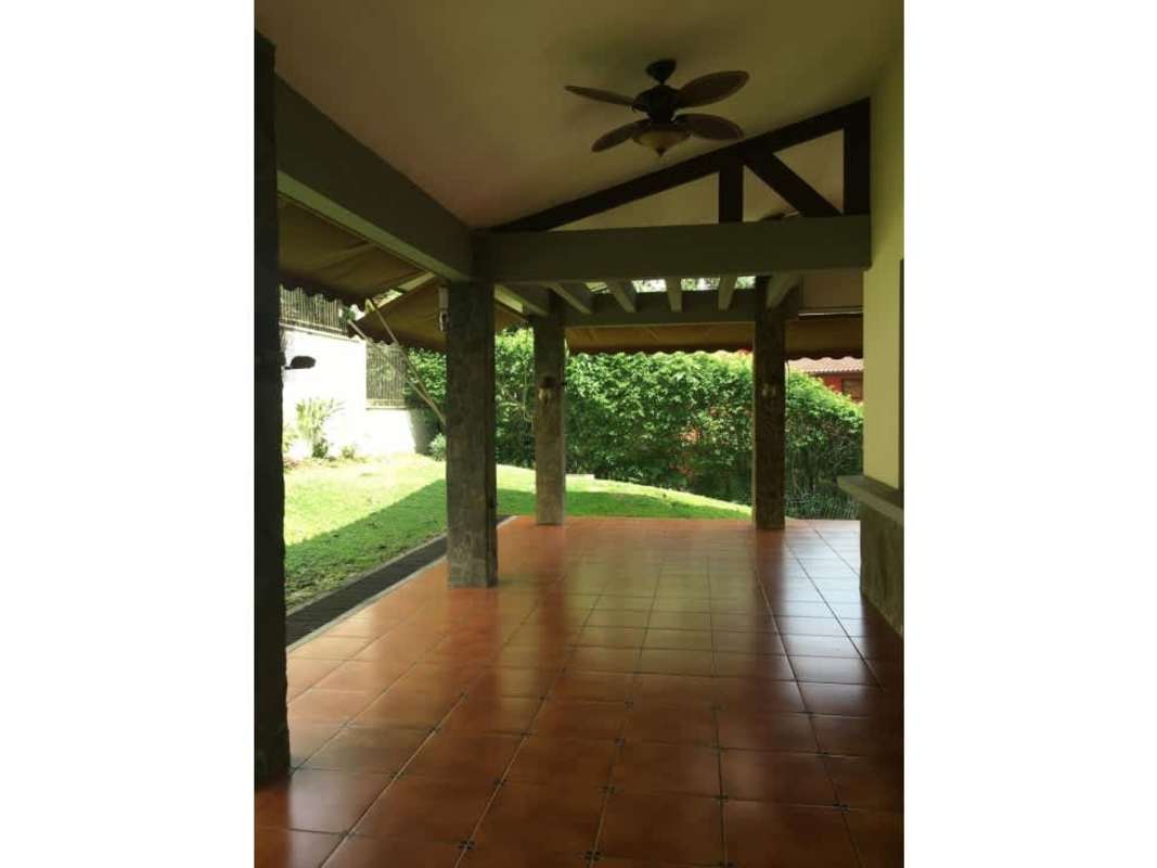 Covered patio terrace with ceiling fan overlooking lush garden Clayton house for sale Panama