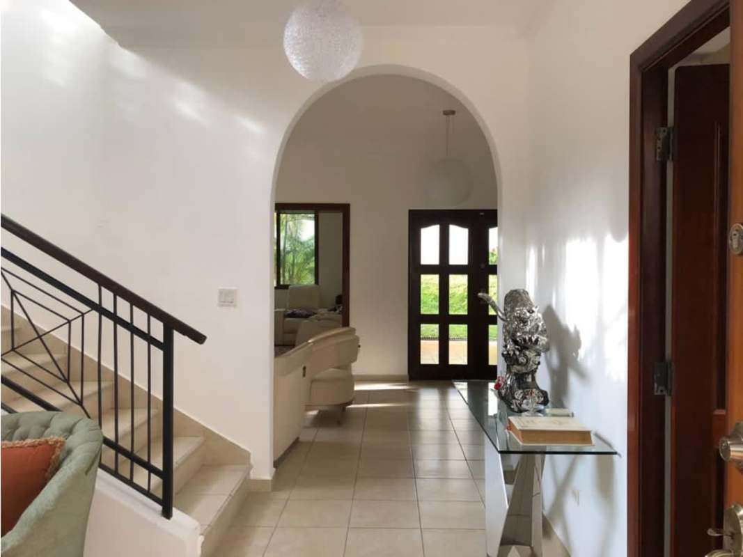 Entry hall with arch doorway, stairs, tile floors house Clayton Panama