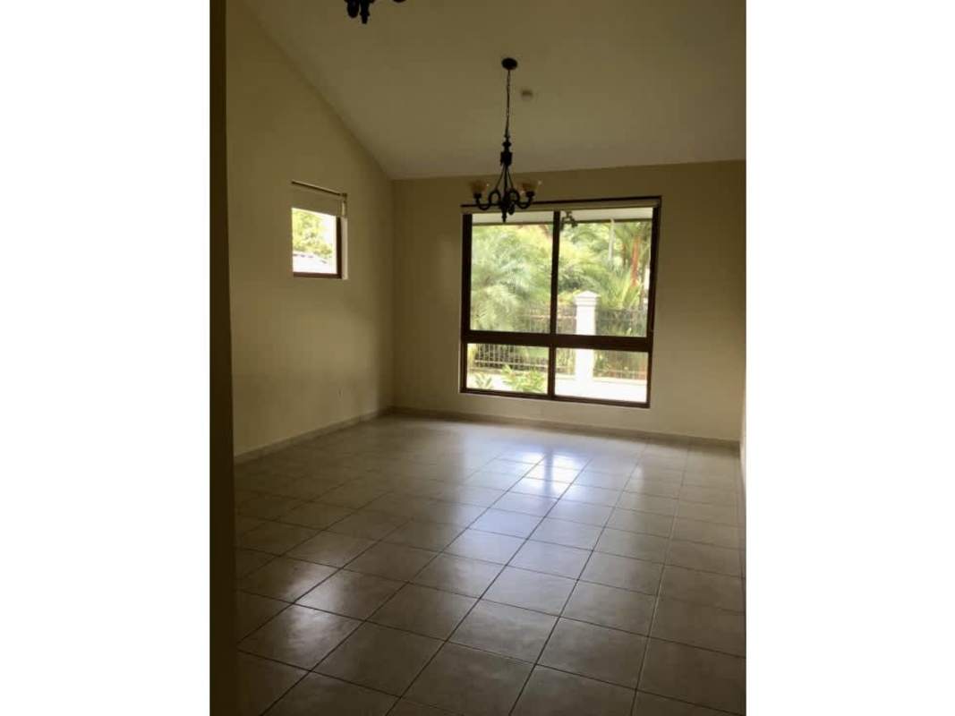 Living room area with large window chandelier tiled floors Clayton Panama house sale