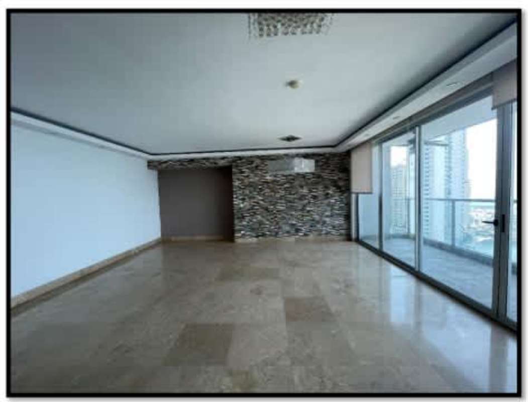 Living space of luxury apartment with marble floors, balcony, stone accent wall Punta Pacifica Panama