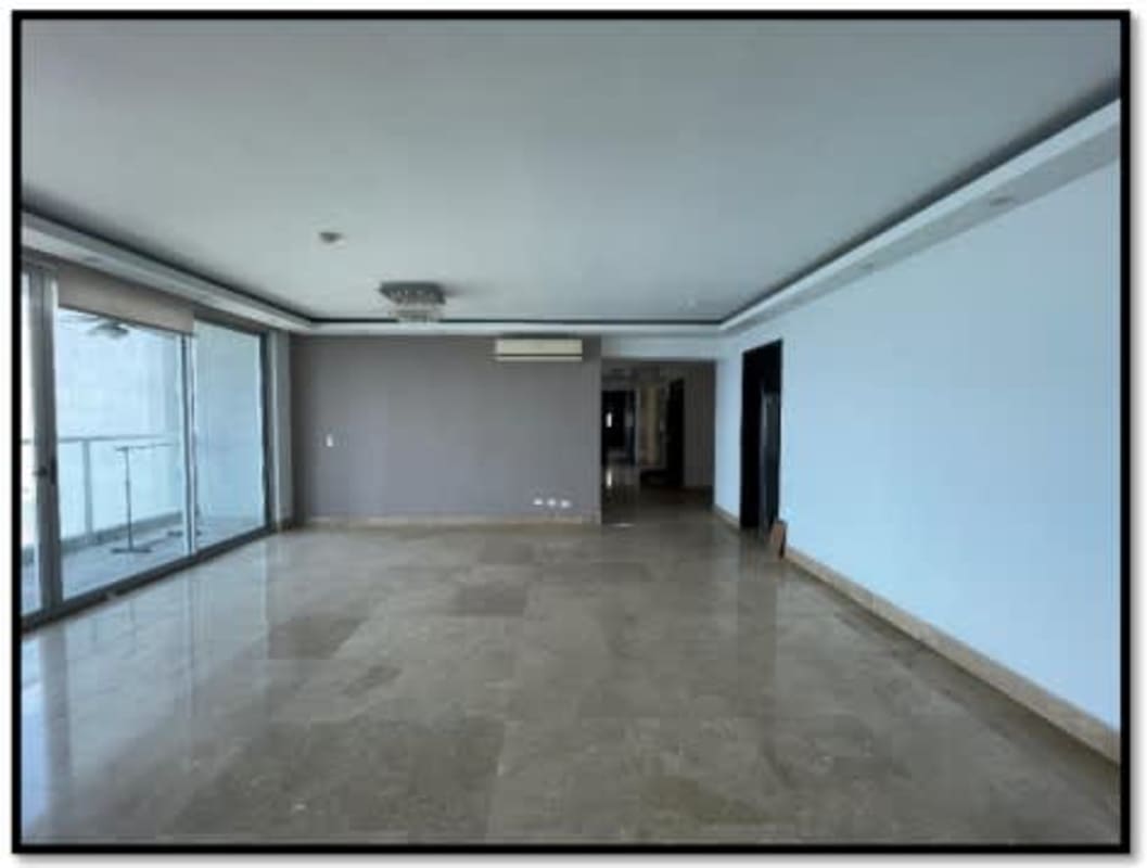 Large living area with marble floors, floor-to-ceiling glass doors to balcony in PH Q Tower Punta Pacifica Panama