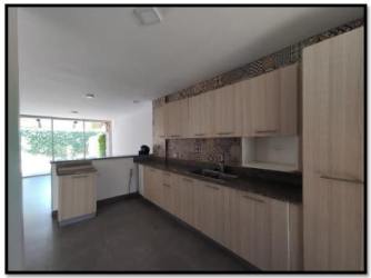 Kitchen with wood cabinets dark countertop decorative backsplash garden window villa iguana panama