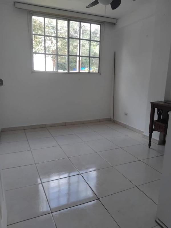 Bedroom featuring closet, large window, tile floor at Villa de las Fuentes apartment Panama City