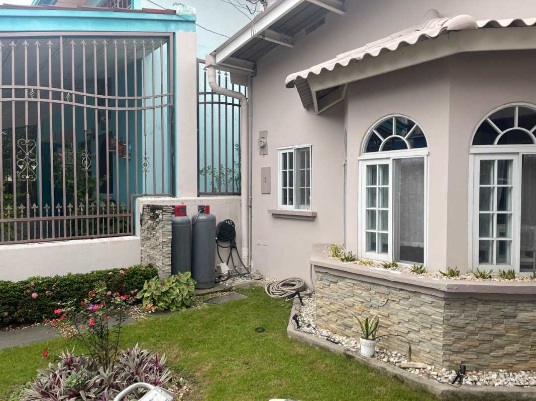 Contemporary kitchen gray cabinets, granite countertops, stove oven, stylish backsplash in Panama City house