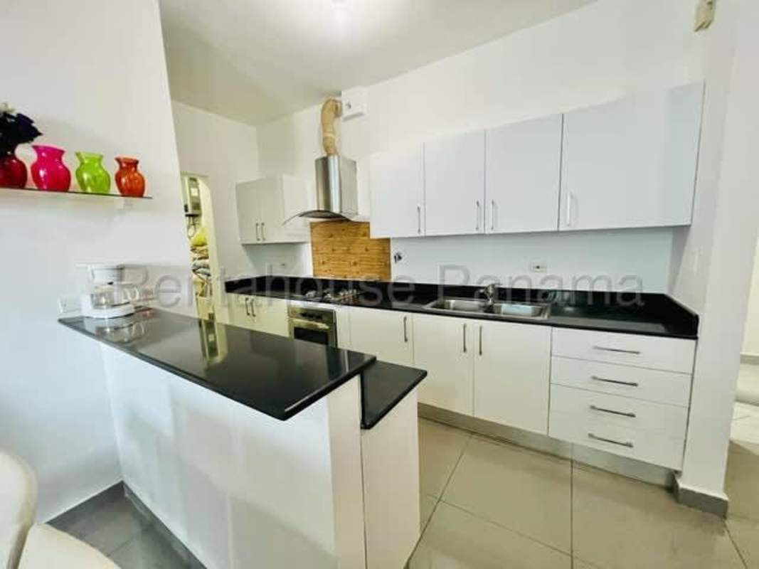 Open plan living and dining room with balcony access in PH Quartier 74 Via Porras Panama City