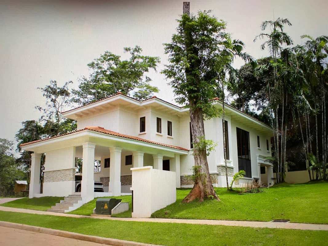 Two-story luxury home porch columns red tiled roof landscaped yard Panama