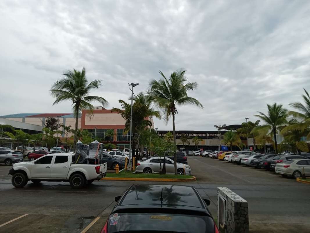 Los Pueblos Shopping Center view showing storefront strip with parking Rufina Alfaro area Panama