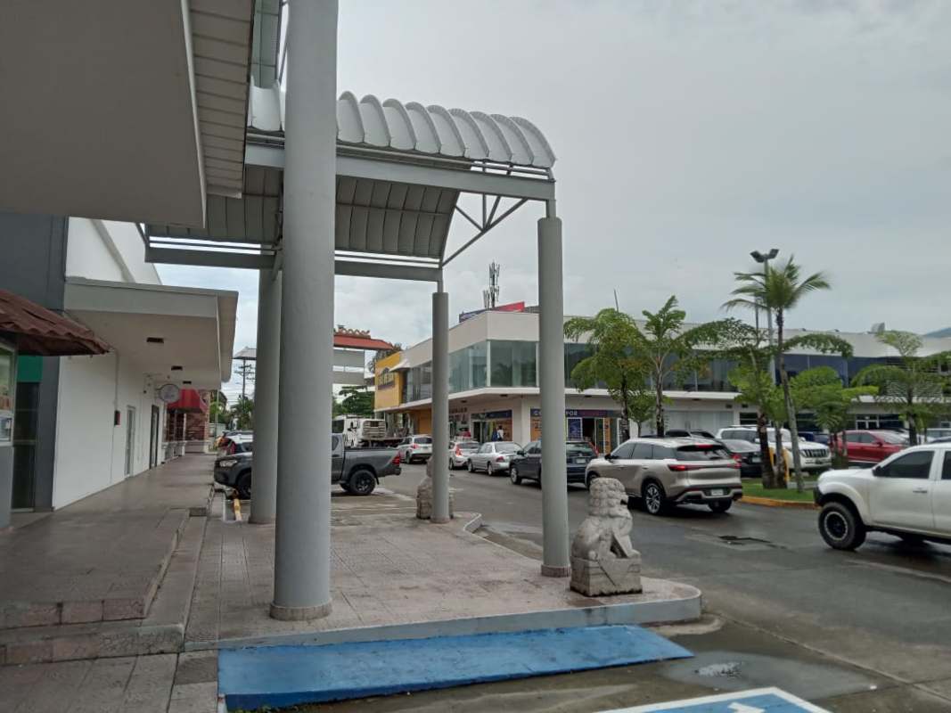 Large parking area at Los Pueblos Shopping Center with retail spaces visible Panama