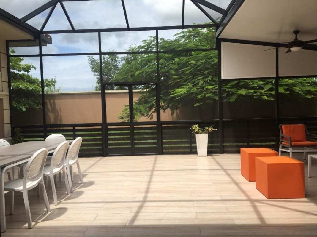 Modern bathroom with natural stone tiles, walk-in shower at PH Sunset Coast Costa Sur Panama