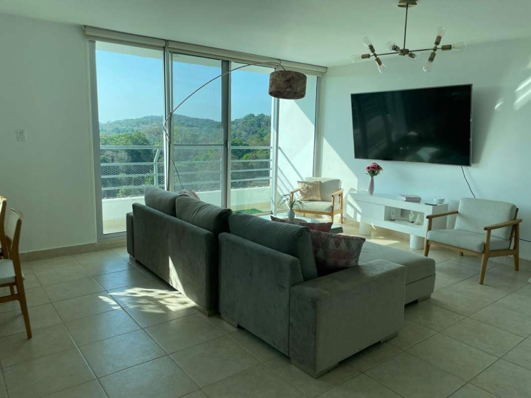 Equipped gym with weights, cardio machines, large windows in Parklane Clayton Panama