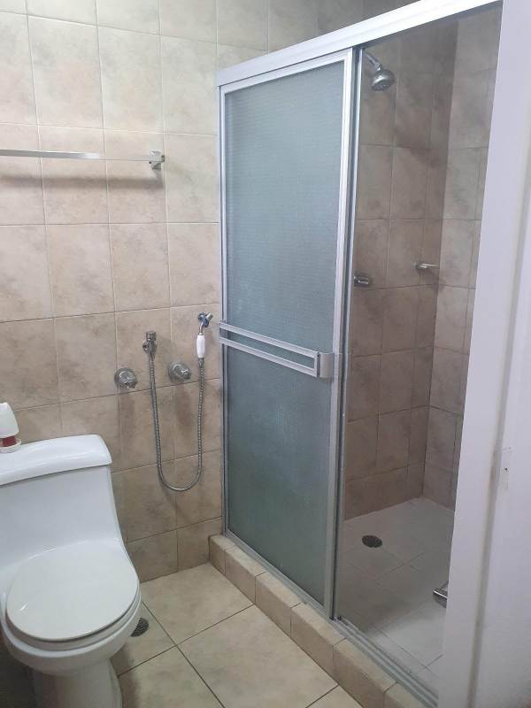 Living room with large windows and tile flooring at PH Green Park Condado del Rey Panama