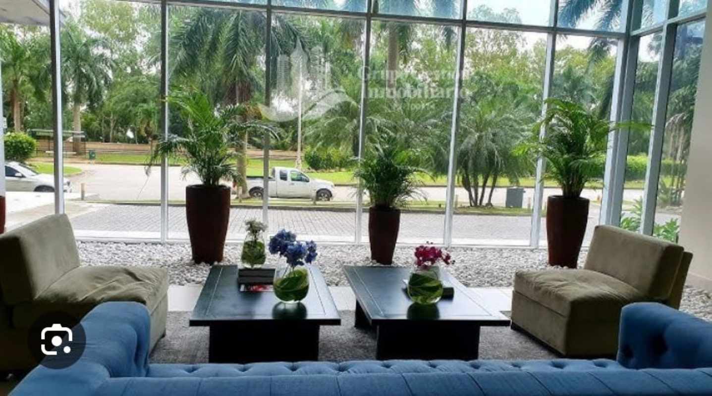 Spacious furnished lobby PH Riverside Costa del Este Panama with floor-to-ceiling windows and greenery views