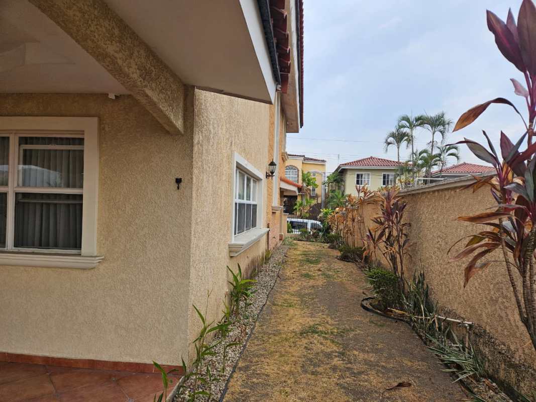 Covered porch with decorative columns, tile flooring at El Doral house Panama City