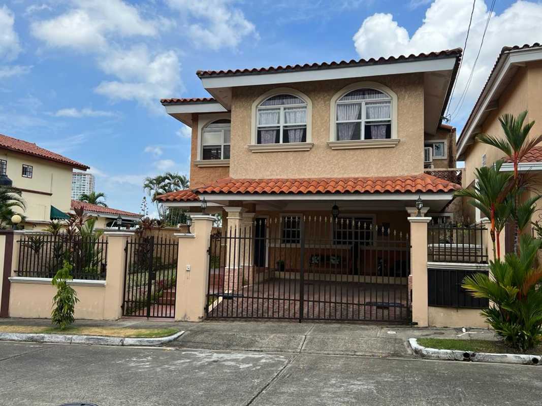 Two-story Mediterranean house with tiled roof, gated driveway, balcony in El Doral Panama City