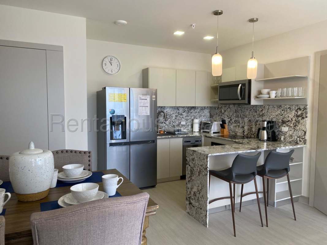 Dining space adjacent to living room with panoramic view in PH Riverside Panama City