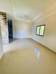 Modern living space with large window porcelain tiles in house in Bugaba
