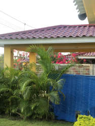 Lush tropical garden and covered patio area at beach house in Santa Clara Panama