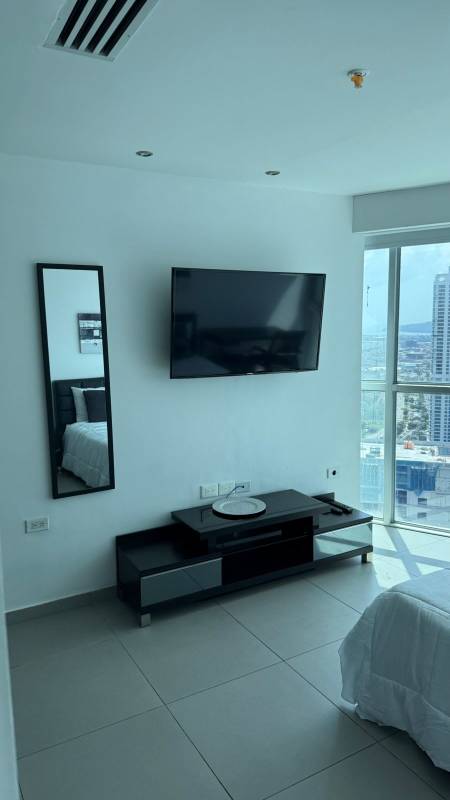 Main bedroom featuring king bed, balcony with ocean views, desk, PH BICSA Tower Panama