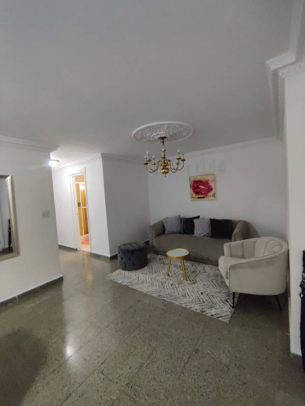 Living room with chandelier, sofa, ceiling molding in PH Juan Pablo Segundo Panama City
