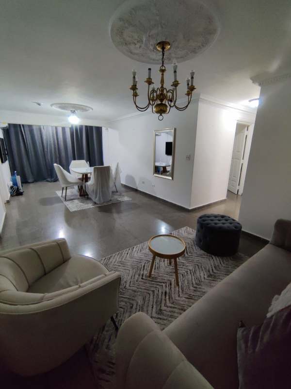 Traditional style living room with gray sofa, chandelier, crown molding in PH Juan Pablo Segundo Panama City